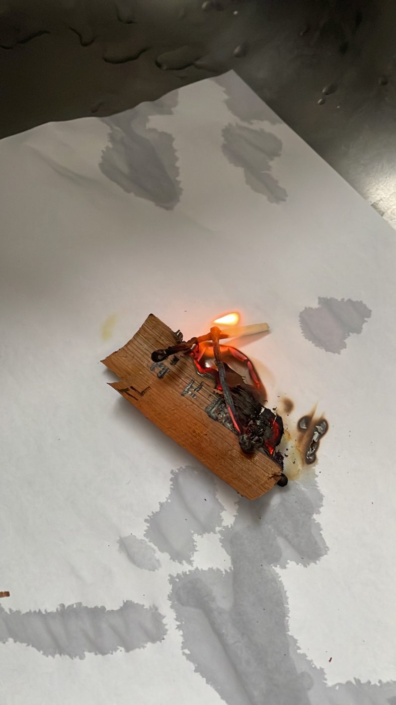 The same fragment with a match flame touching it