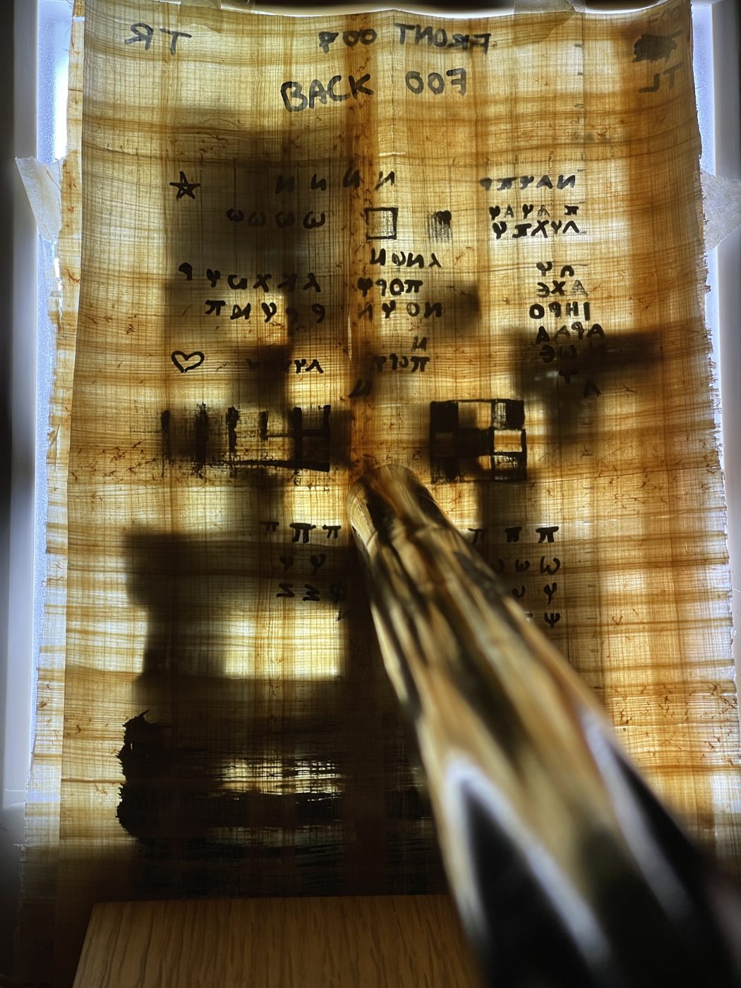 Looking through a glass lens at the backlit checkerboard sheet