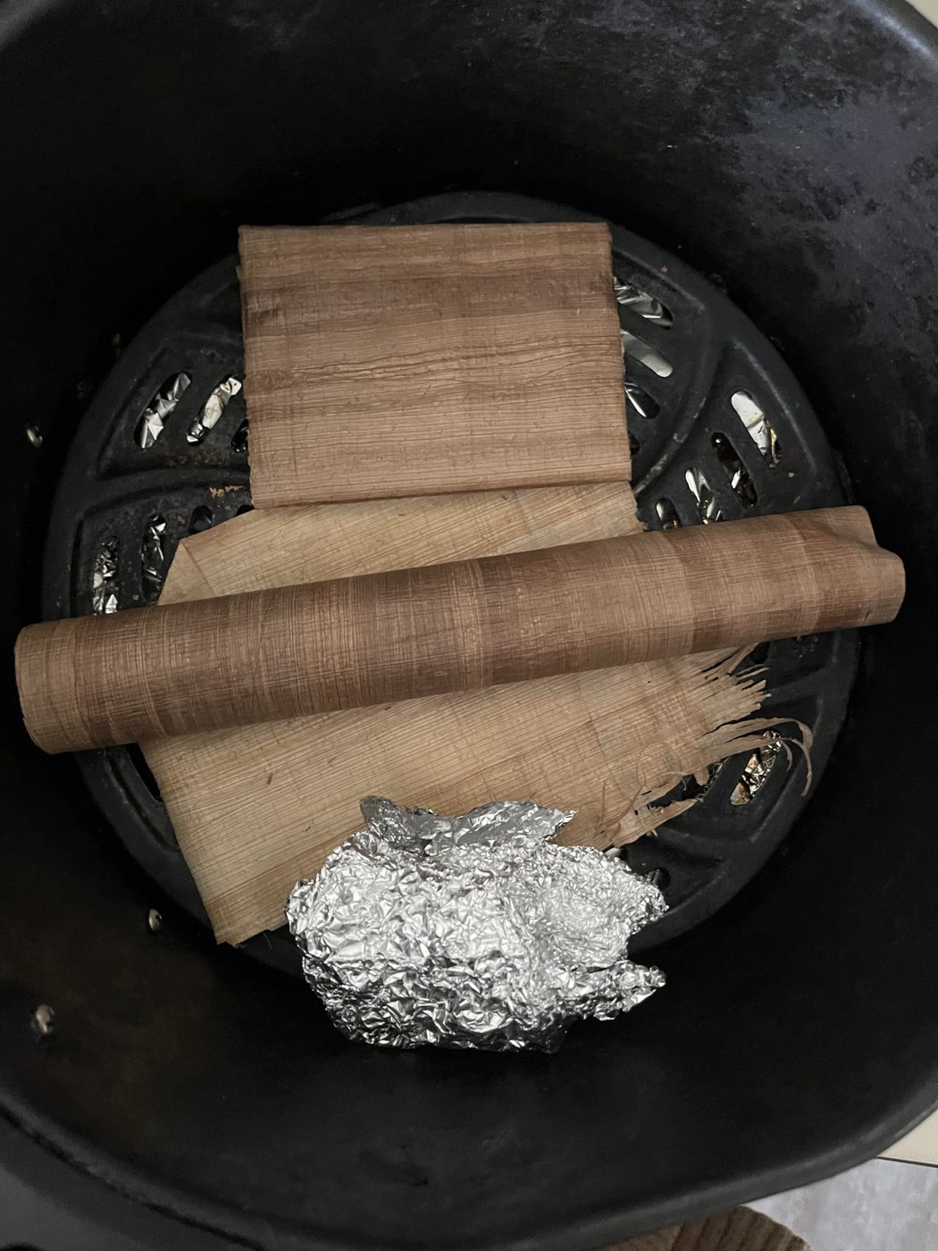 Toasted papyrus sheets and a rolled scroll in the air fryer basket